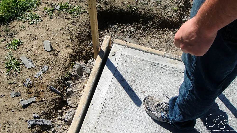 Our project walkway is almost complete now that the DIY concrete is set. Check out the pictures of how it looks currently and read my pros and cons of going with a DIY walkway versus professional concrete.