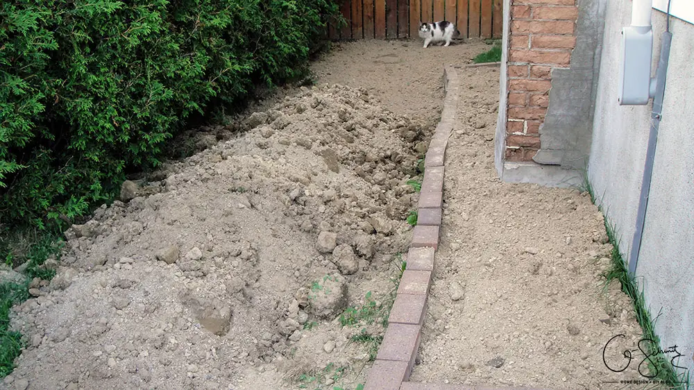 Our project walkway is almost complete now that the DIY concrete is set. Check out the pictures of how it looks currently and read my pros and cons of going with a DIY walkway versus professional concrete.