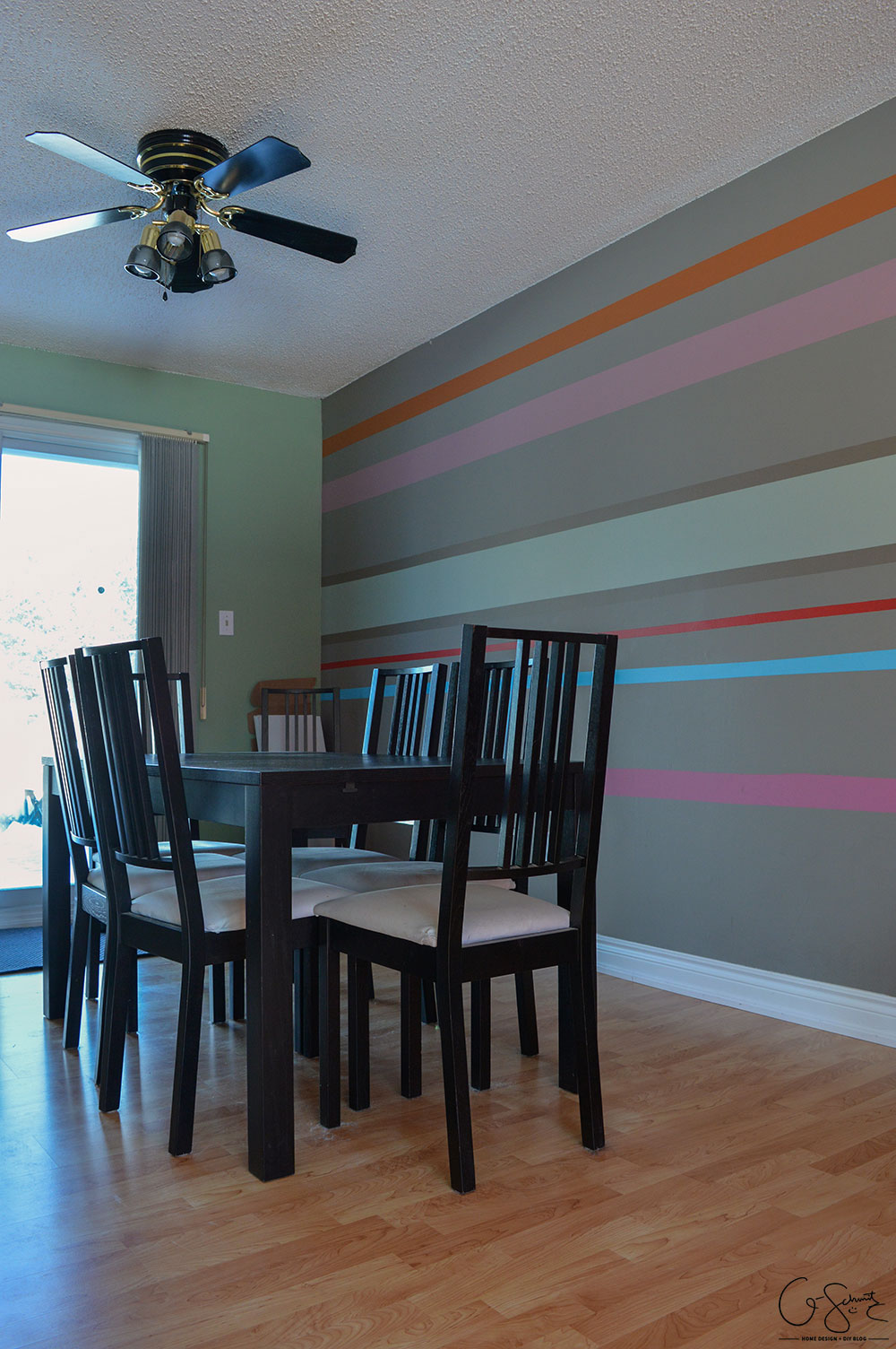 The living and dining room are two combined spaces in our house. Check out pictures of these two areas and the striped accent wall that joins them both together. 