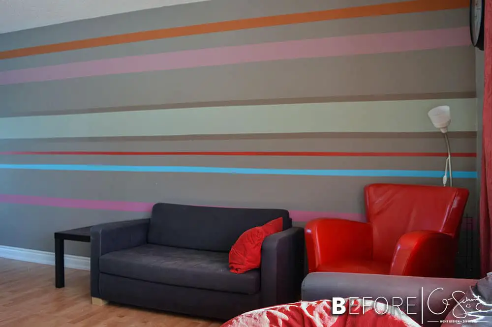Our striped accent wall helps bring all the crazy and wild colours we used throughout the house into one cohesive location!