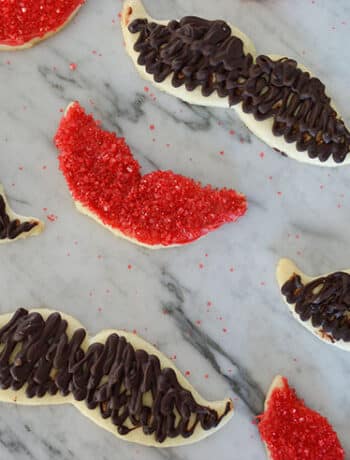 mustache and lip cookies on counter