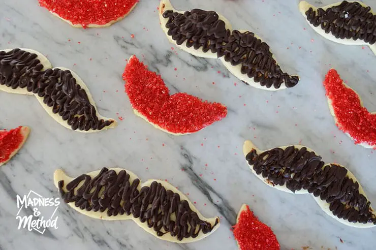 mustache and lip cookies on counter