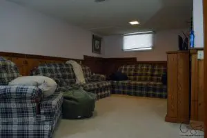 My basement is definitely "country". Think plaid and dark wood paneling, and that pretty much describes this space. You know what style I am not? Country! But, let's look at pictures of the basement anyways, along with my lovely little comments of issues I would change...