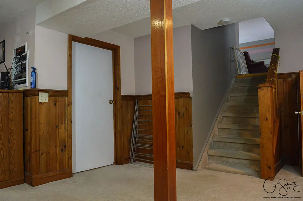 My basement is definitely "country". Think plaid and dark wood paneling, and that pretty much describes this space. You know what style I am not? Country! But, let's look at pictures of the basement anyways, along with my lovely little comments of issues I would change...