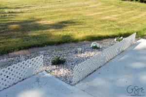 Check out these cute and easy trellis mini-fences that I wanted to install to add height and definition to the flowerbed along our front walkway.