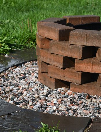 This quick and simple project uses patio pavers and finishing stones to update a not-so-pretty firepit into a pretty and easy DIY firepit!