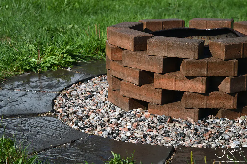 This quick and simple project uses patio pavers and finishing stones to update a not-so-pretty firepit into a pretty and easy DIY firepit!