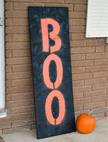 I made a custom DIY light up board "Boo" sign because I wanted something that would look good in both the daytime and at night. This large marquee-like sign is the perfect addition to our front porch!