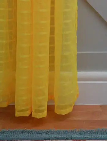 bright yellow curtain on gray wall and white trim