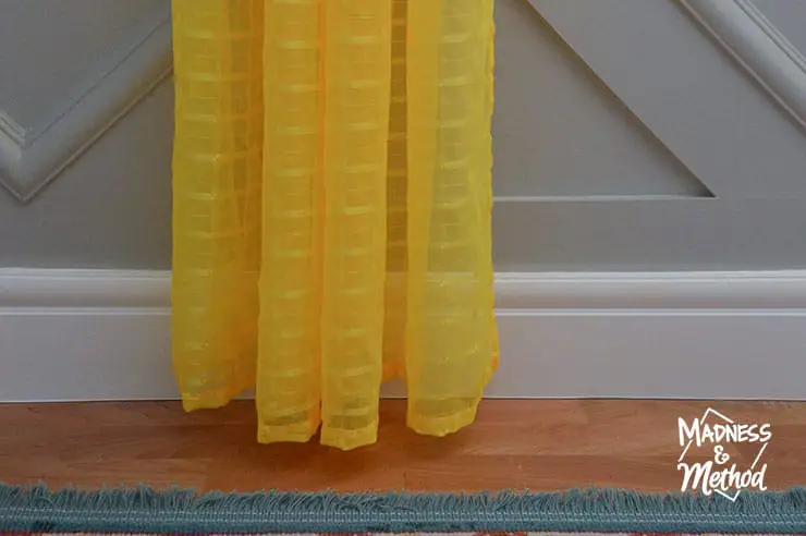 bright yellow curtain on gray wall and white trim