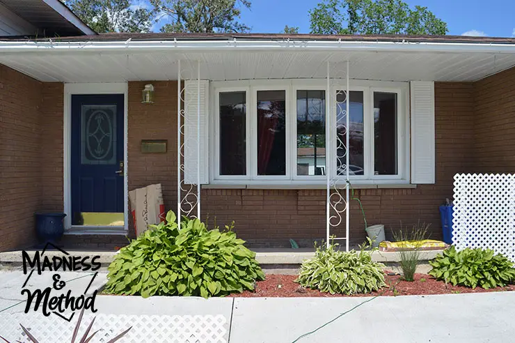 Front house view with concrete front porch and bay window