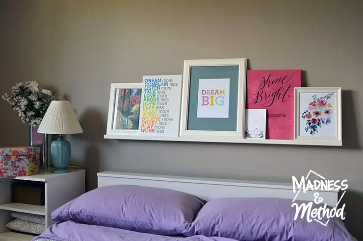 Photo ledge behind a bed in a bedroom