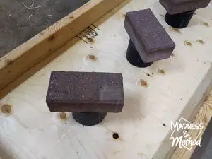 Holding glue down with bricks