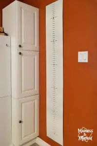 baby growth chart in an orange bathroom