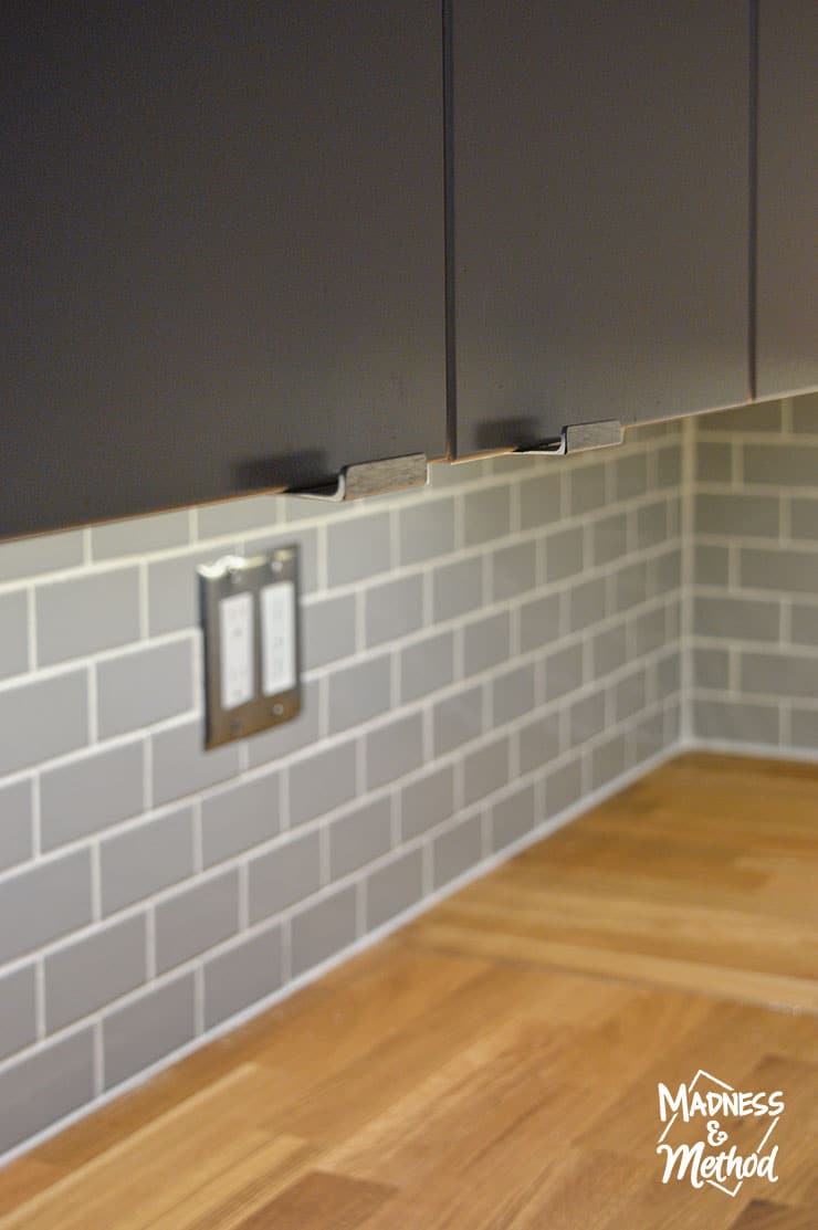 gray backsplash with wood counters