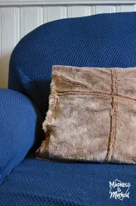 faux fur pillow on blue couch