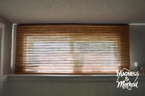 short windows in basement with bamboo blinds