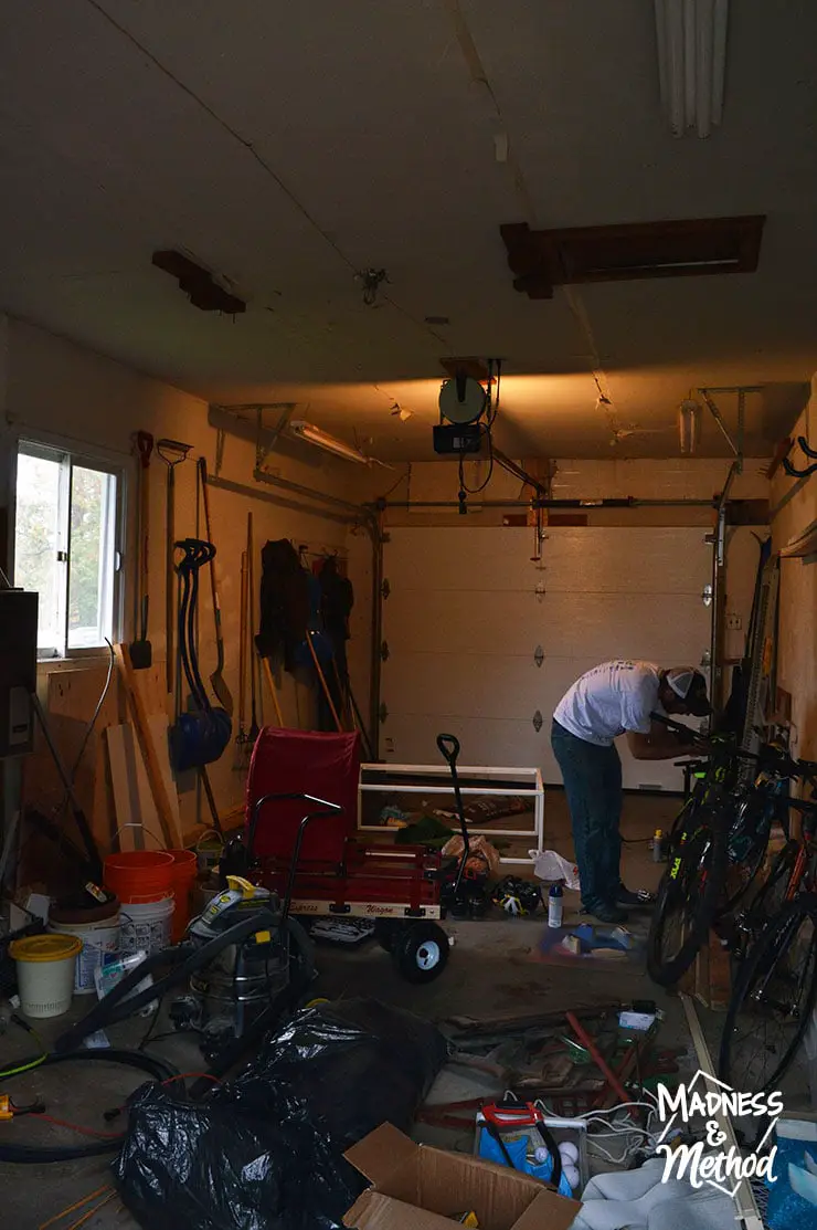 looking back at the door in messy garage