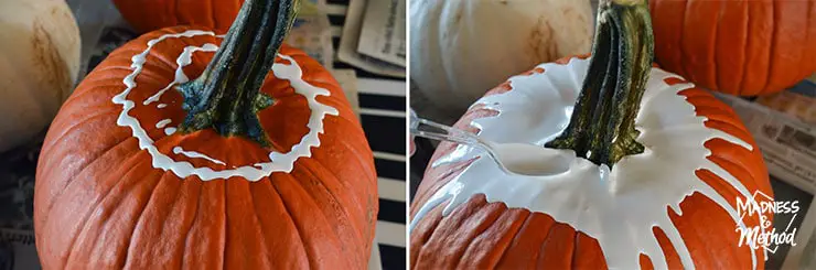 spreading paint on pumpkins for paint-drip technique