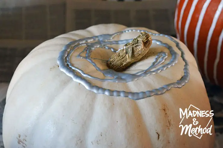 pouring paint on pumpkins