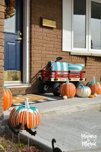 paint-drip pumpkin setup on front porch