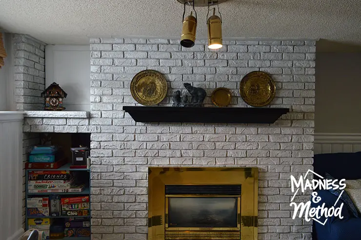 painted gray and white bricks with black mantel