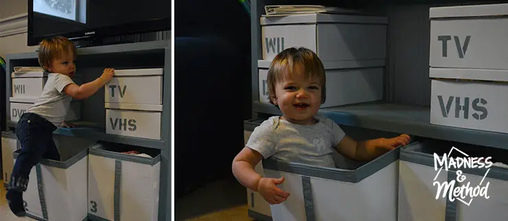 baby playing in toy boxes