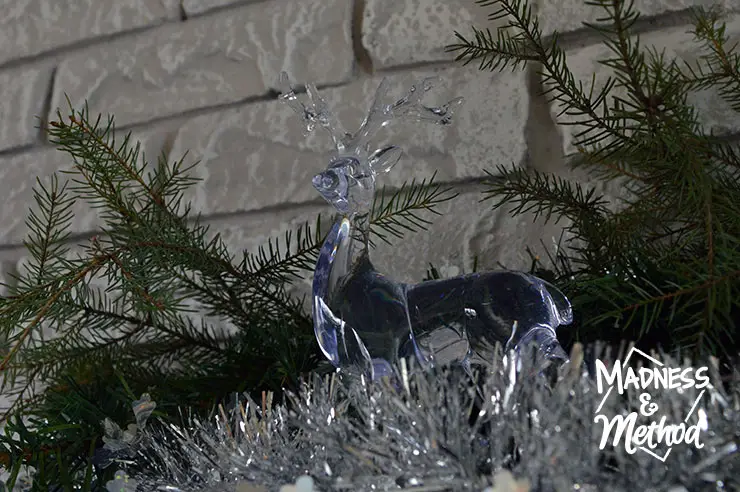 clear reindeer on holiday mantel