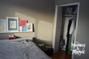 gray guest bedroom with messy closet