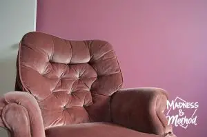 pink velvet chair against pink wall