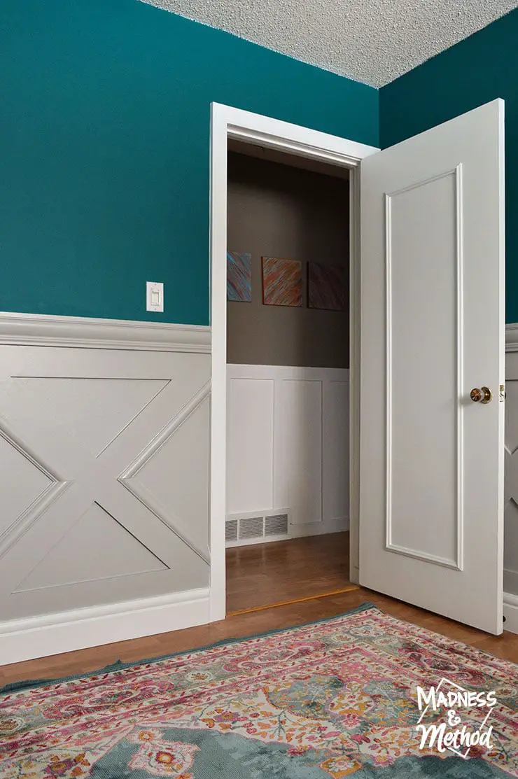 white doors with dark teal walls