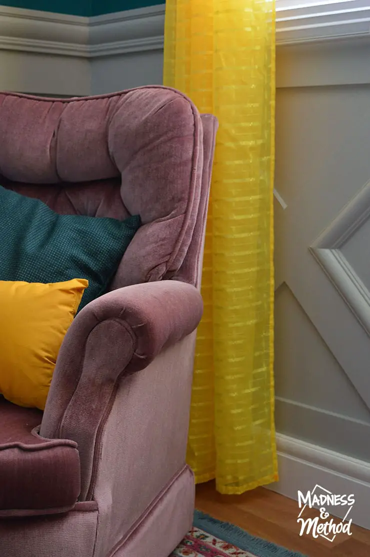 pink chair with yellow curtains