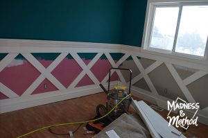 placing flat trim panels to make diamond wainscoting