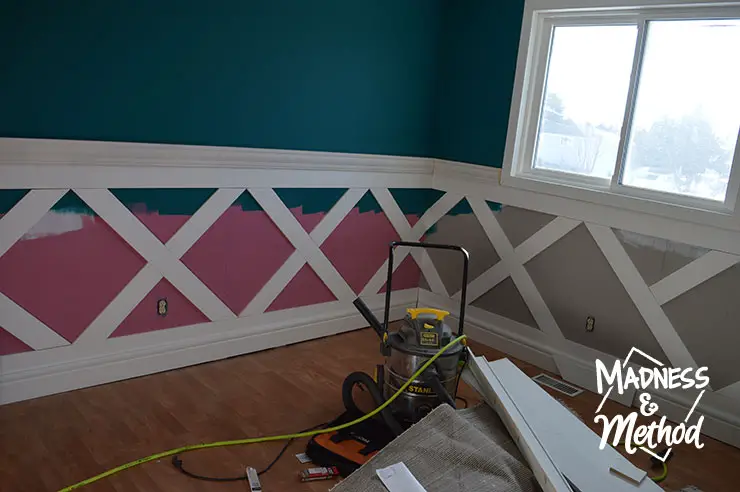 placing flat trim panels to make diamond wainscoting