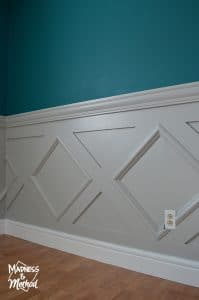 gray wainscoting and deep teal walls