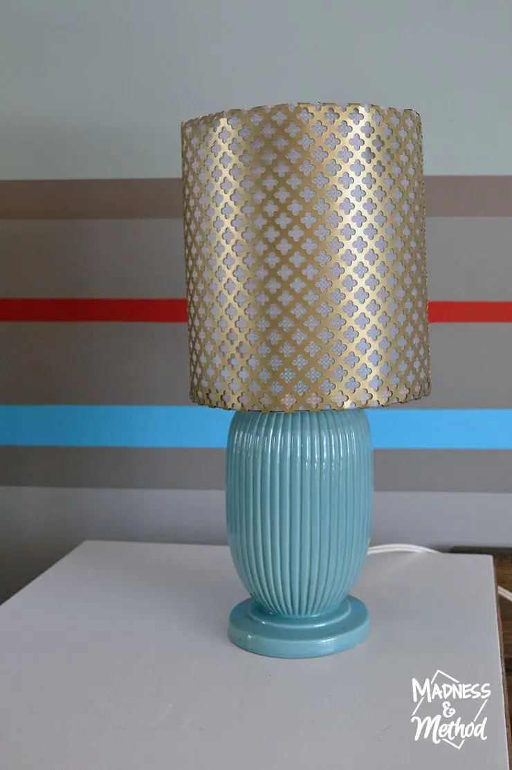 brass metal lampshade on turquoise base