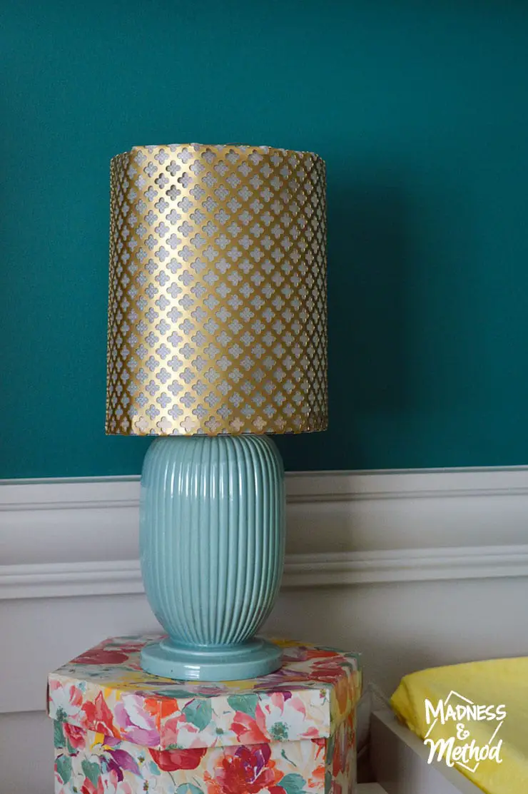 brass metal lampshade on turquoise base