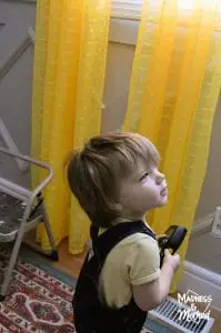 baby helping install curtains