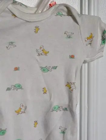 baby t-shirt hung on closet