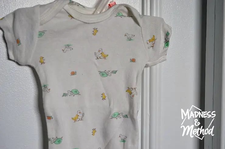 baby t-shirt hung on closet