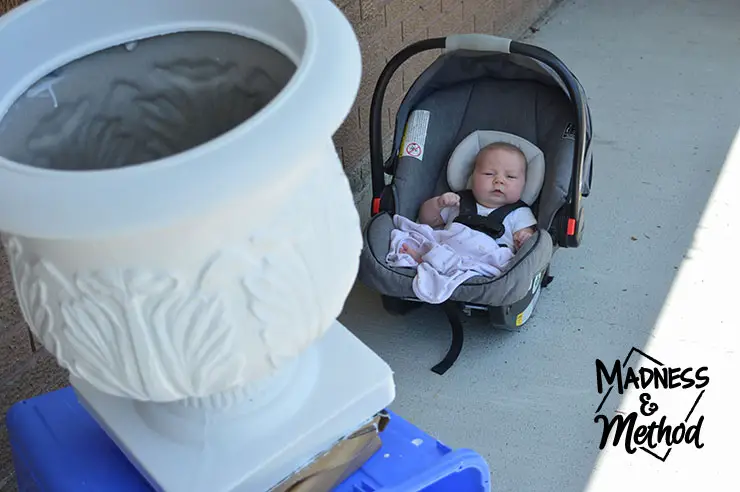 painting the planter white with baby in background