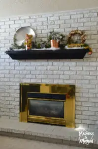 shiny brass fireplace surround