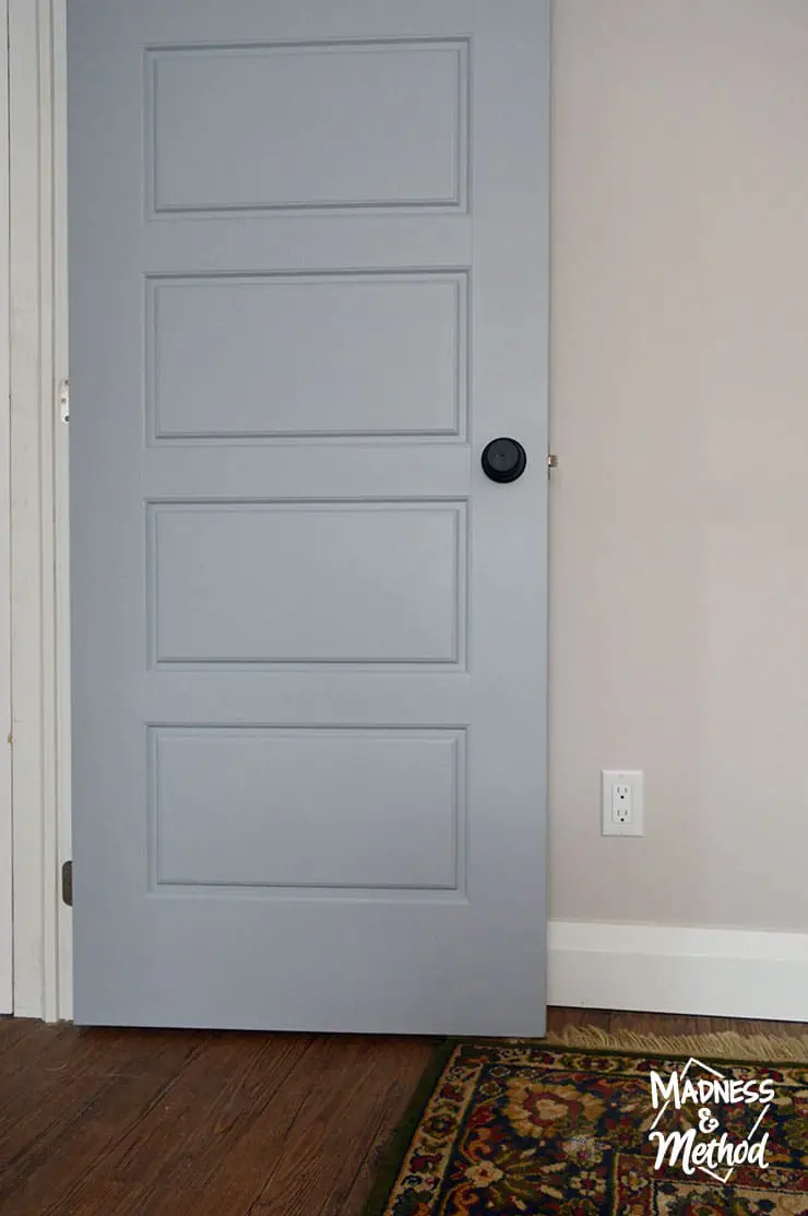 blue gray door with black hardware