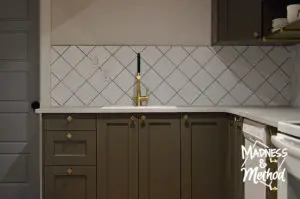gold faucet with white backsplash