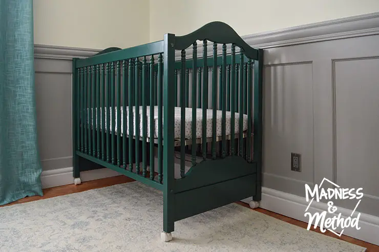 dark teal crib and light rug