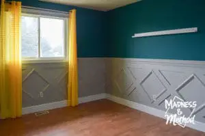 teal bedroom with gray wainsoting
