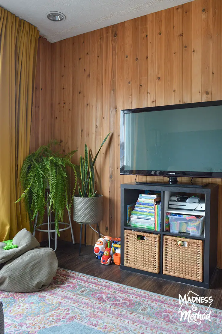 wood paneled wall behind tv