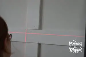 using laser level to install wall treatment