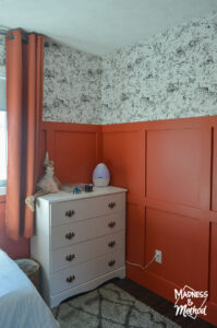 white dresser with red walls