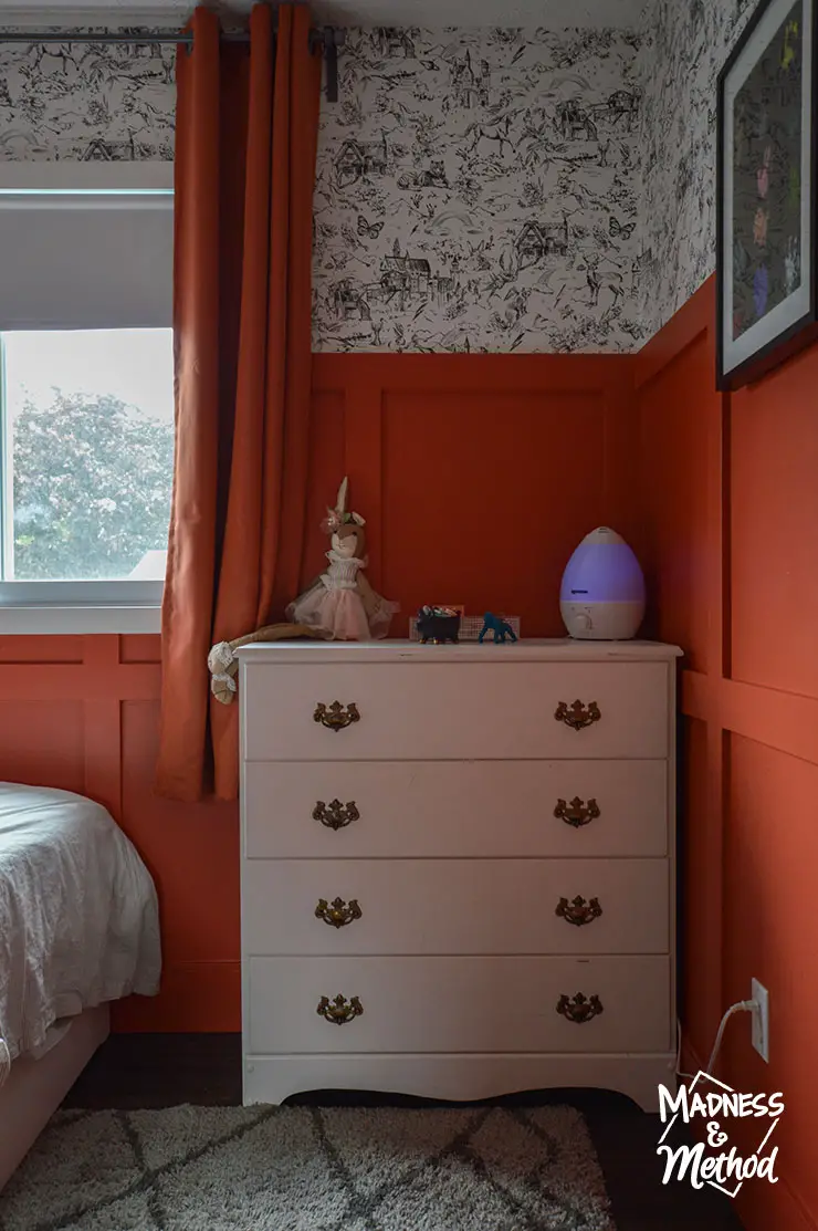 red walls white dresser gray carpet